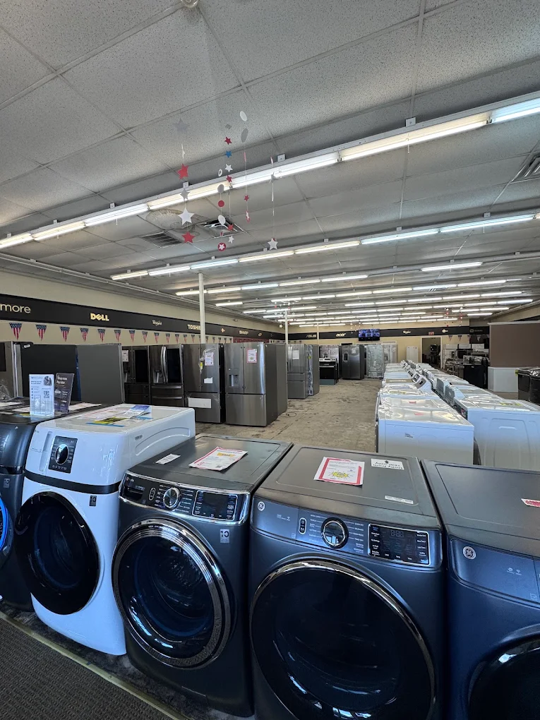 Rows of washers, dryers and refrigerators inside the appliance showroom
